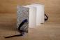 Preview: Standing leporello with light pages, book cover with colorful birds of paradise and ornaments, blue ribbon